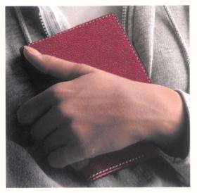 holding red notebook